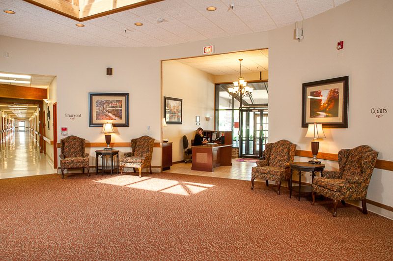 A well-lit lobby with comfortable seating and a reception desk.