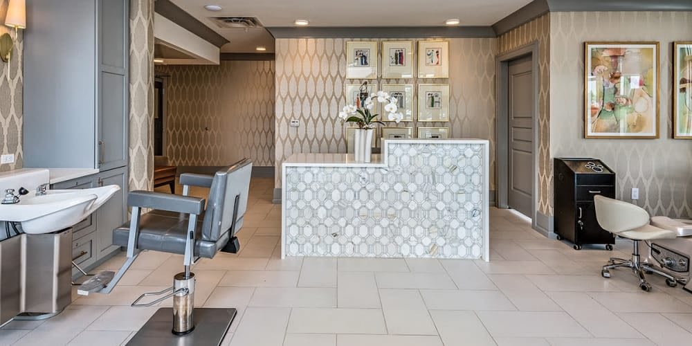 A modern office reception area with a stylish desk and decorative elements.