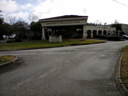 An overview of the entrance to a building, set against a cloudy sky.