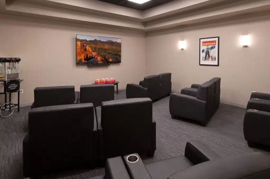 A modern home theater with comfortable seating and a large television.