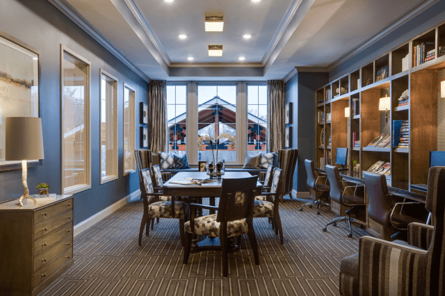 A modern office conference room with stylish furniture and large windows.