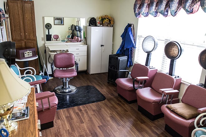A small hair salon interior with barber chairs and styling equipment.