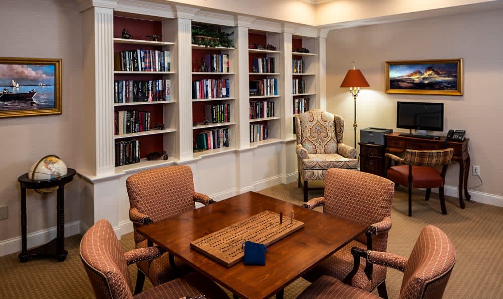 Cozy library room with bookshelves and a seating area.