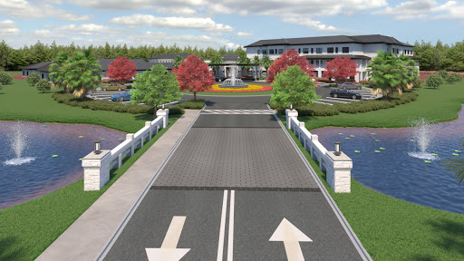 A beautifully designed entrance showcasing a landscaped area with vibrant trees, water features, and a modern building in the background.