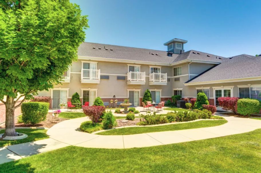 A sunny day at a residential building with landscaped gardens and walkways.
