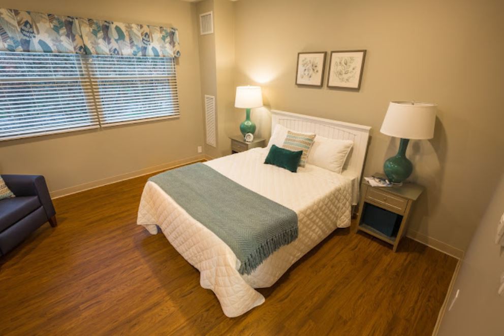 A cozy bedroom with a neatly made bed and elegant decor.