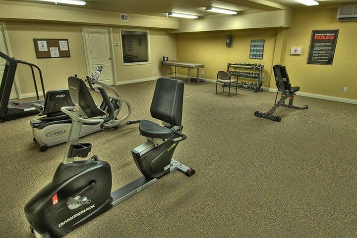 A gym with stationary bikes and exercise equipment.