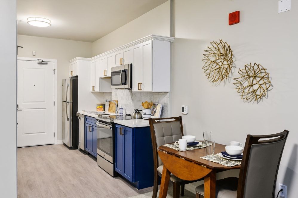 A modern kitchen and dining area with sleek appliances and stylish decor.