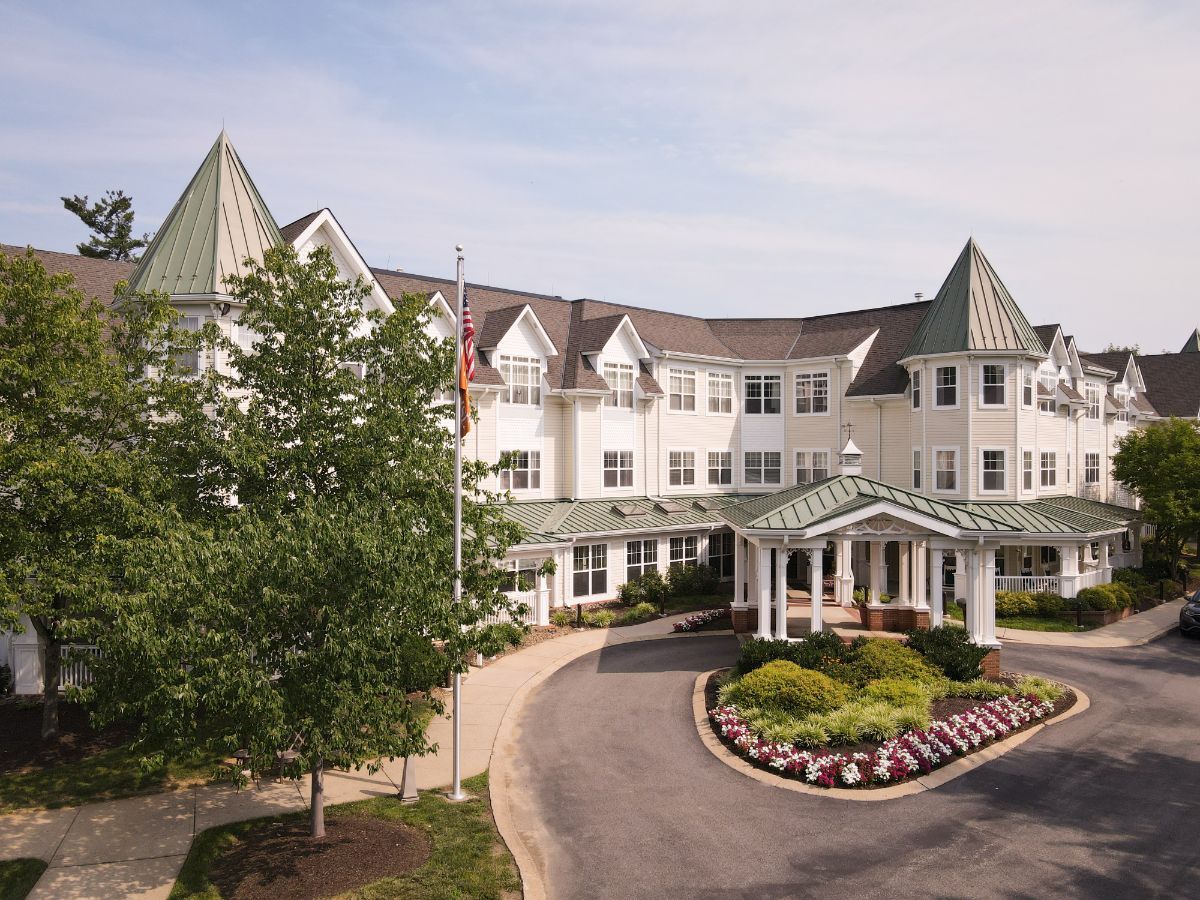 A residential building with a landscaped entrance and circular driveway.