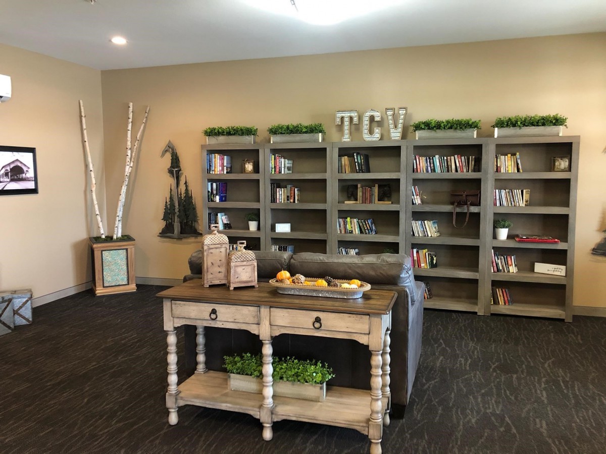 A cozy living room with a bookshelf and decorative elements.