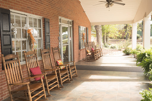A cozy porch featuring several rocking chairs, inviting relaxation and enjoyment of the outdoors.