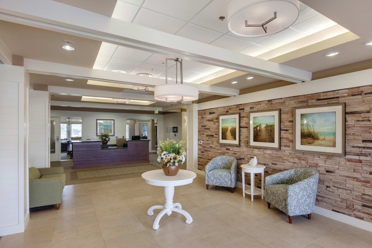 A modern lobby with comfortable seating, decorative lighting, and artwork on the walls.