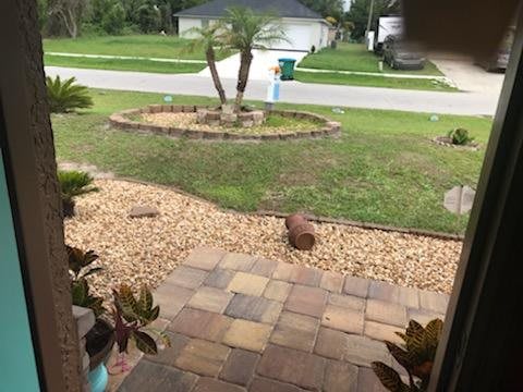 A well-maintained front yard with a paved path and landscaped garden.