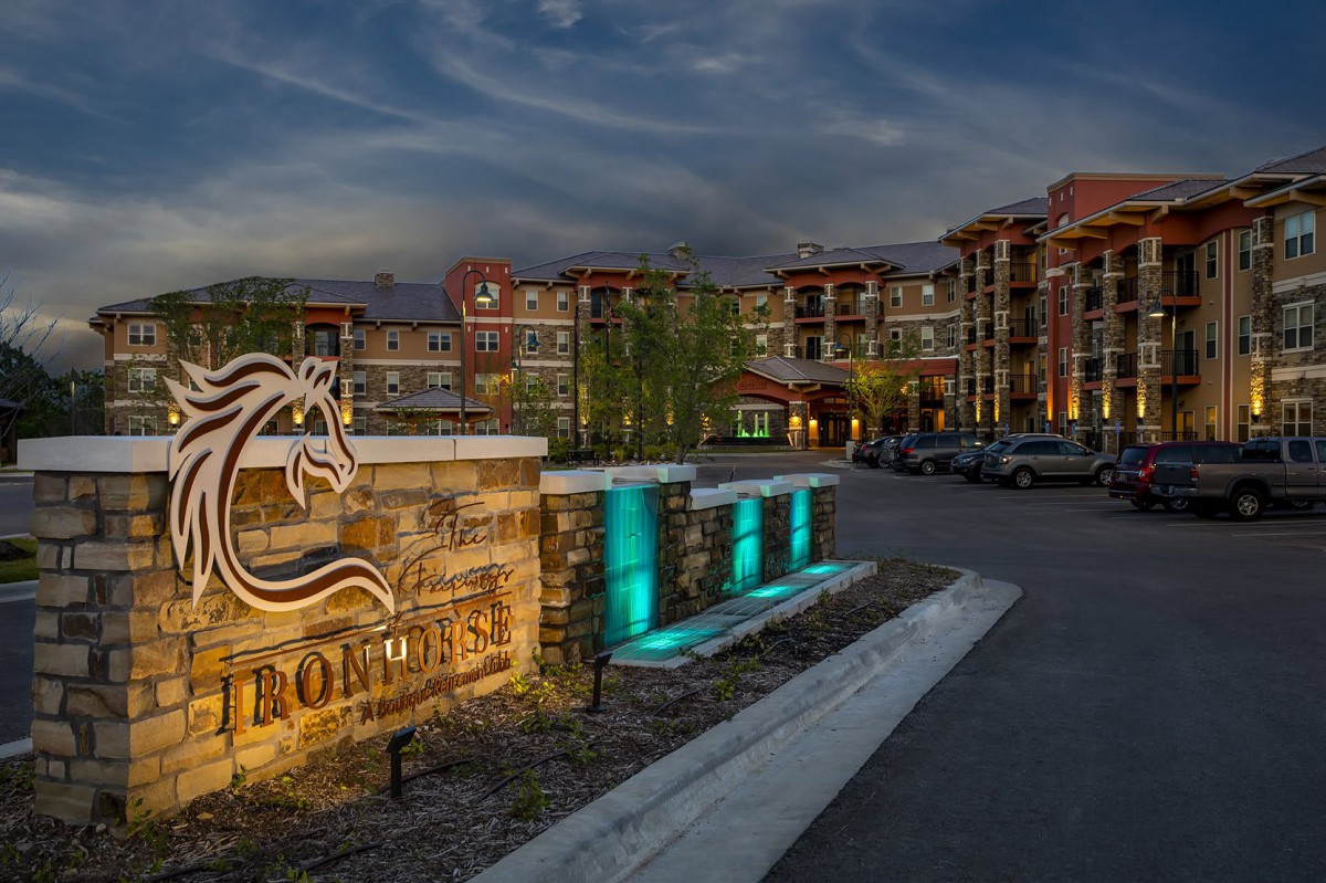 Elegant hotel entrance with illuminated signage and modern architecture at night.