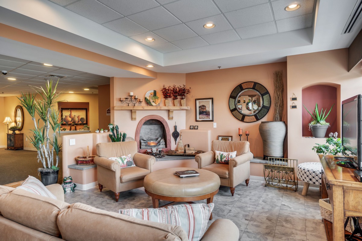 A cozy and elegantly decorated living room with a fireplace and modern furnishings.