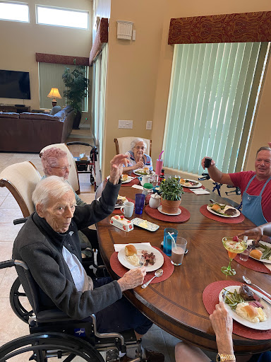 A joyful gathering of friends enjoying a meal together.