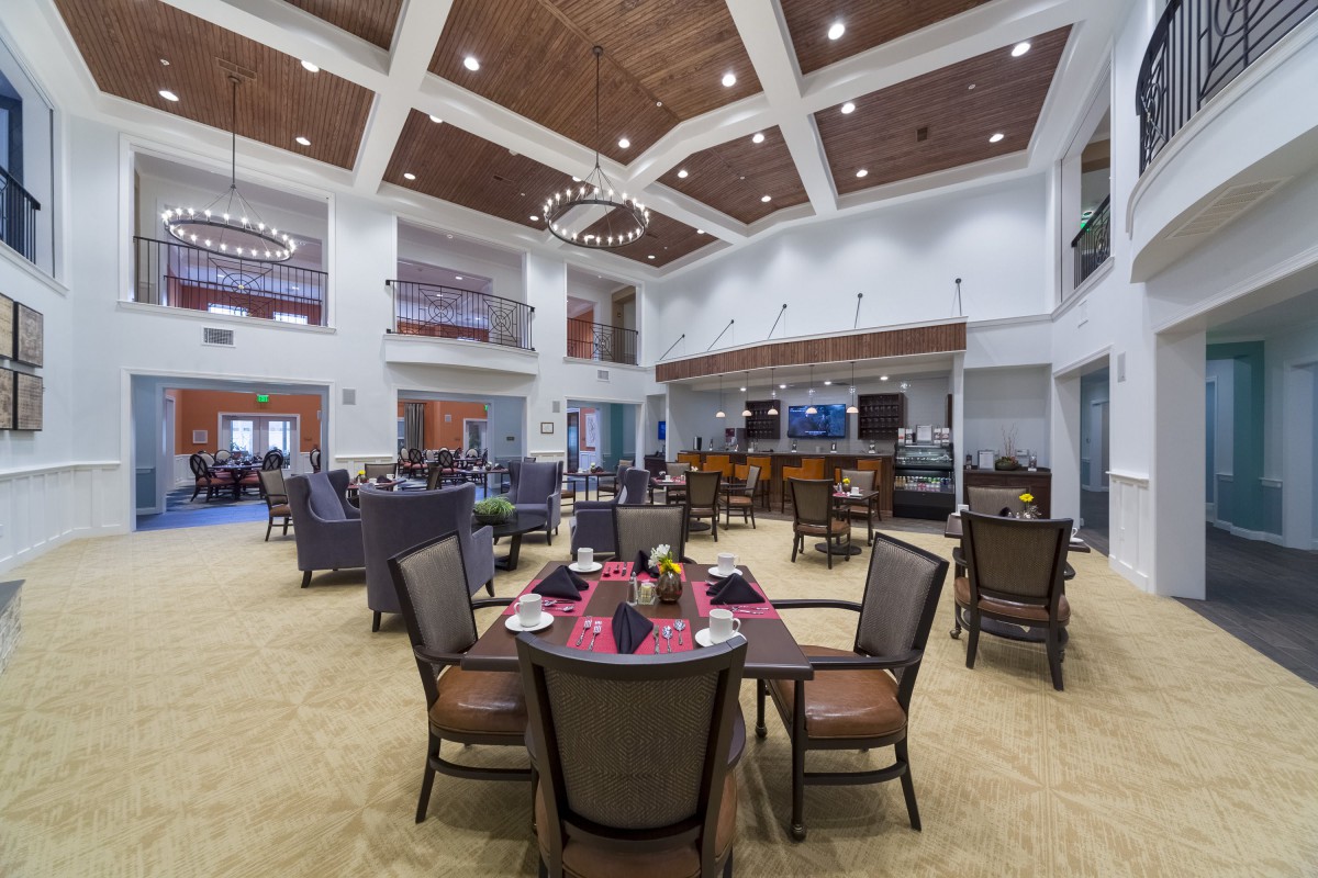 A spacious, modern dining area featuring elegant seating and sophisticated lighting.