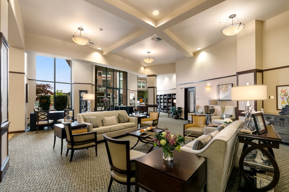 A luxurious and spacious living room featuring modern decor, elegant furniture, and ample lighting.