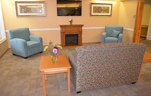 A cozy living room with comfortable seating, a fireplace, and decorative elements.