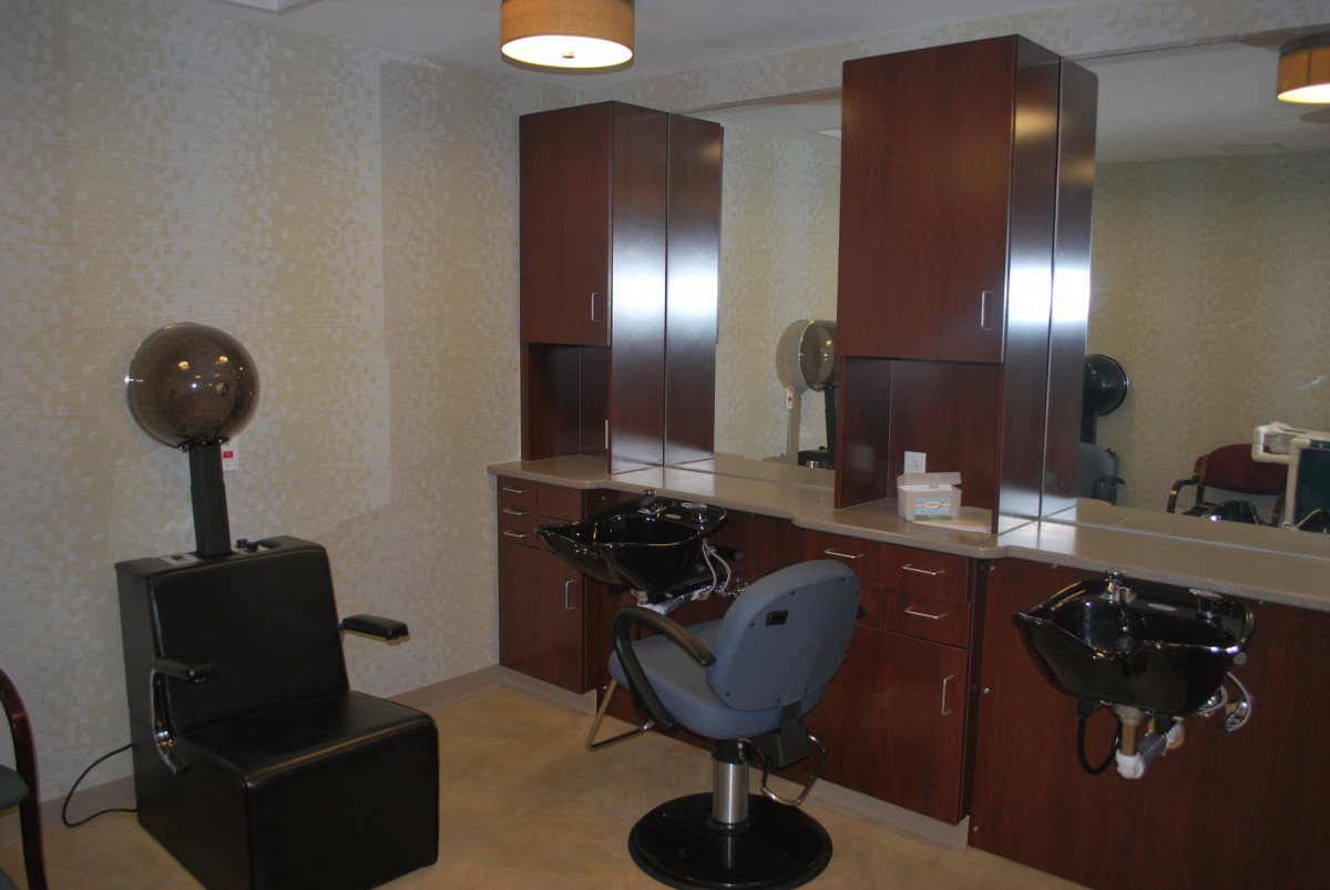 A modern hair salon interior with styling stations and chairs.