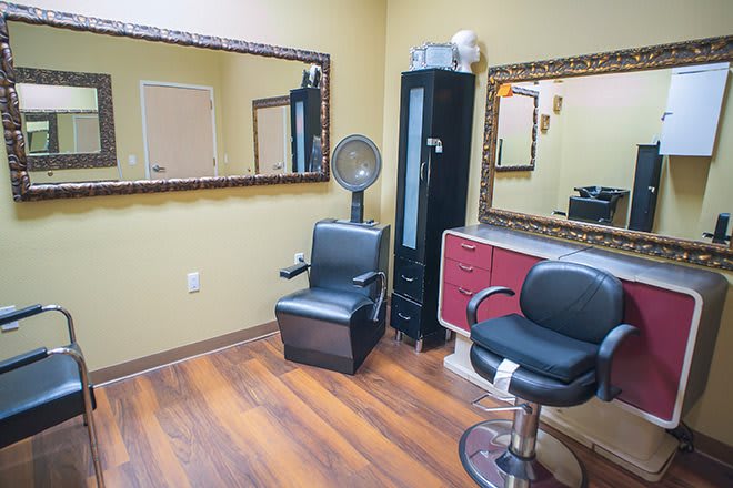 Interior of a hair salon with chairs and mirrors.