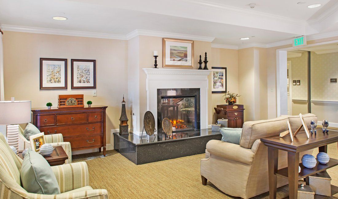 A cozy living room with a fireplace and comfortable seating.