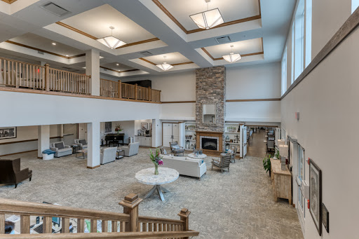 A modern and spacious lobby designed for comfort and relaxation, featuring elegant furnishings and a cozy fireplace.