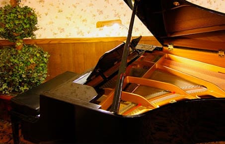 A grand piano in a warmly lit room.
