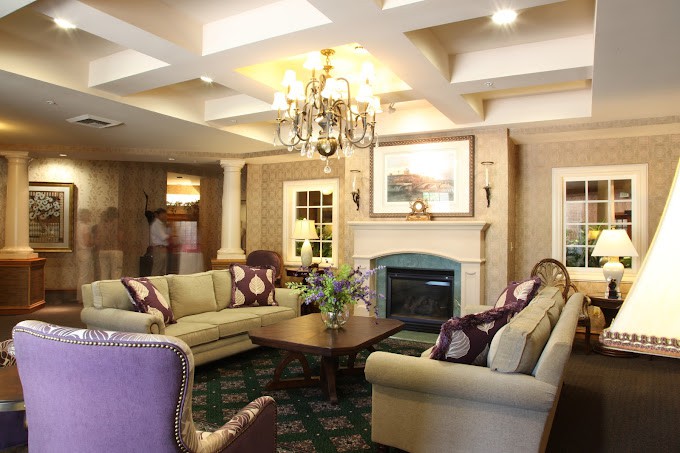 A cozy living room with elegant furnishings and a warm fireplace.