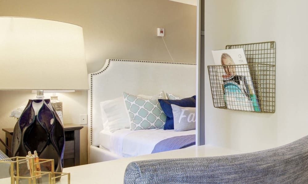 A cozy and well-decorated bedroom with a stylish lamp and comfortable bed.