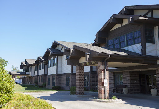 A modern residential building with a distinct architectural design under clear blue skies.