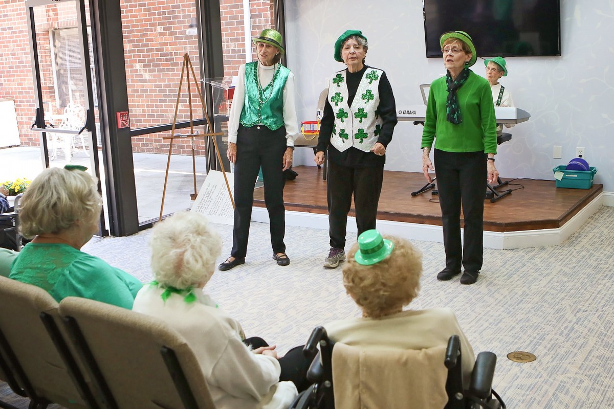 Seniors perform in festive green attire for a St. Patrick's Day celebration.