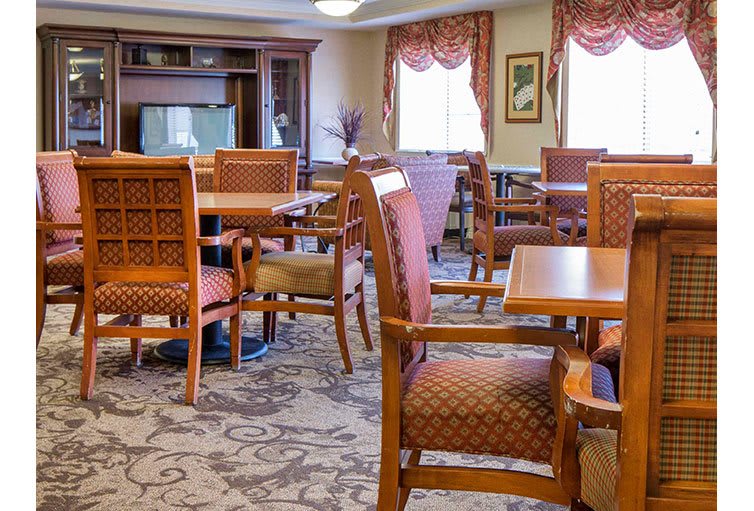 A well-furnished dining area with wooden chairs and tables.