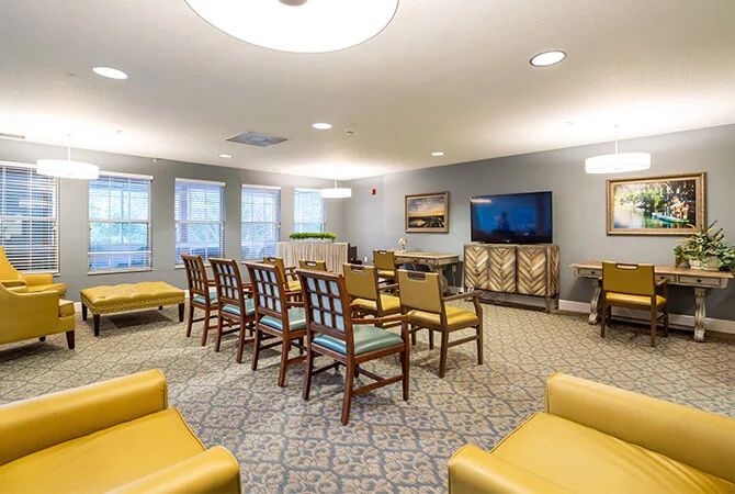 A cozy meeting room with arranged seating and a television.