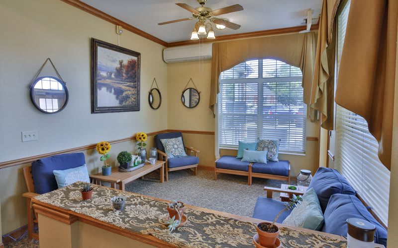 A cozy living room with comfortable seating and decorative elements.