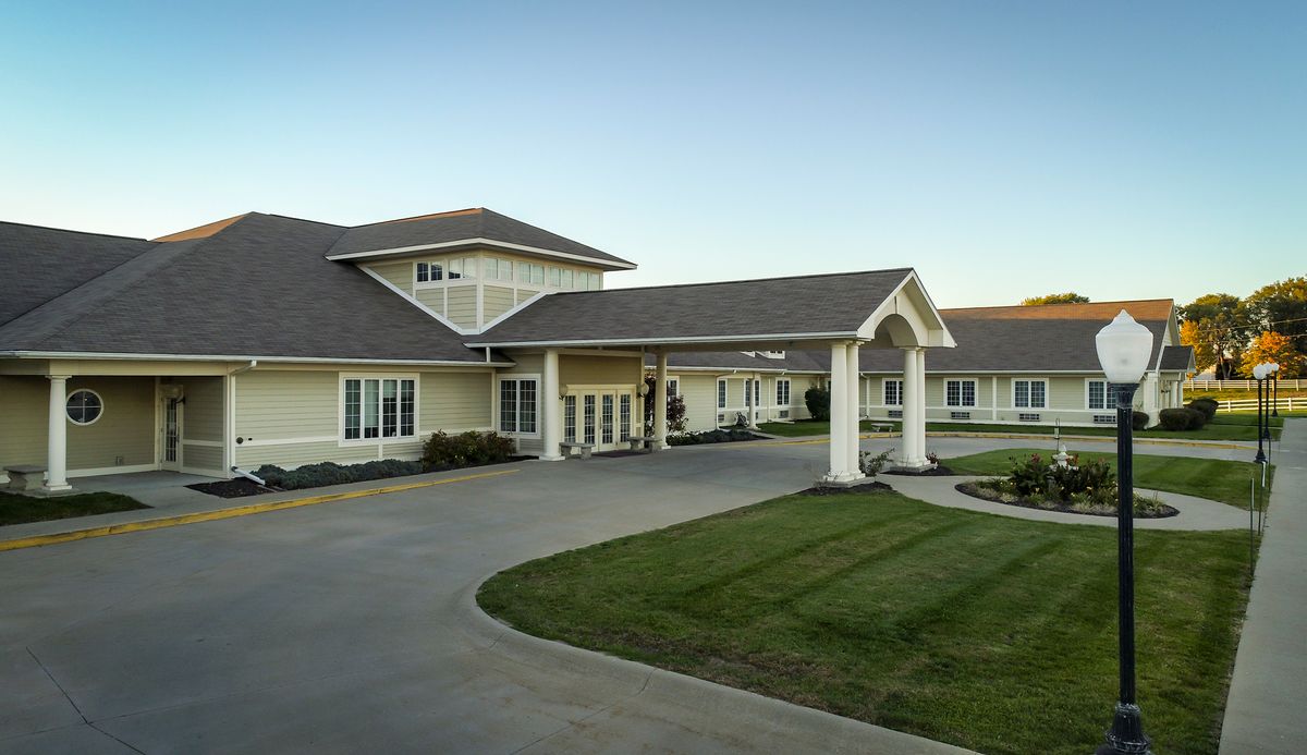 A well-maintained building with a covered entrance and manicured lawn.