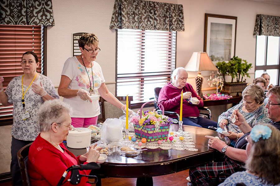 A group of elderly individuals enjoying a social gathering at a care facility.