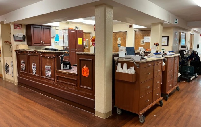 A reception area with wooden desks and office equipment.