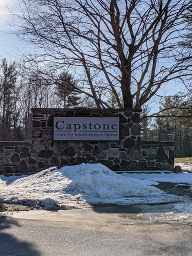 The entrance sign for Capstone surrounded by a snowy landscape.