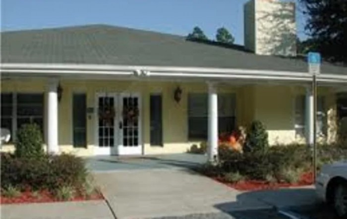 A single-story house with a covered entrance and landscaped front yard.