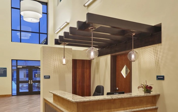 Modern reception area with contemporary lighting and wooden accents.