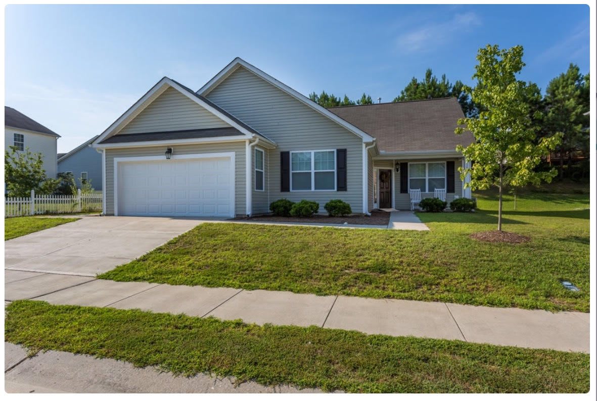 A single-story suburban house with a garage and front yard.