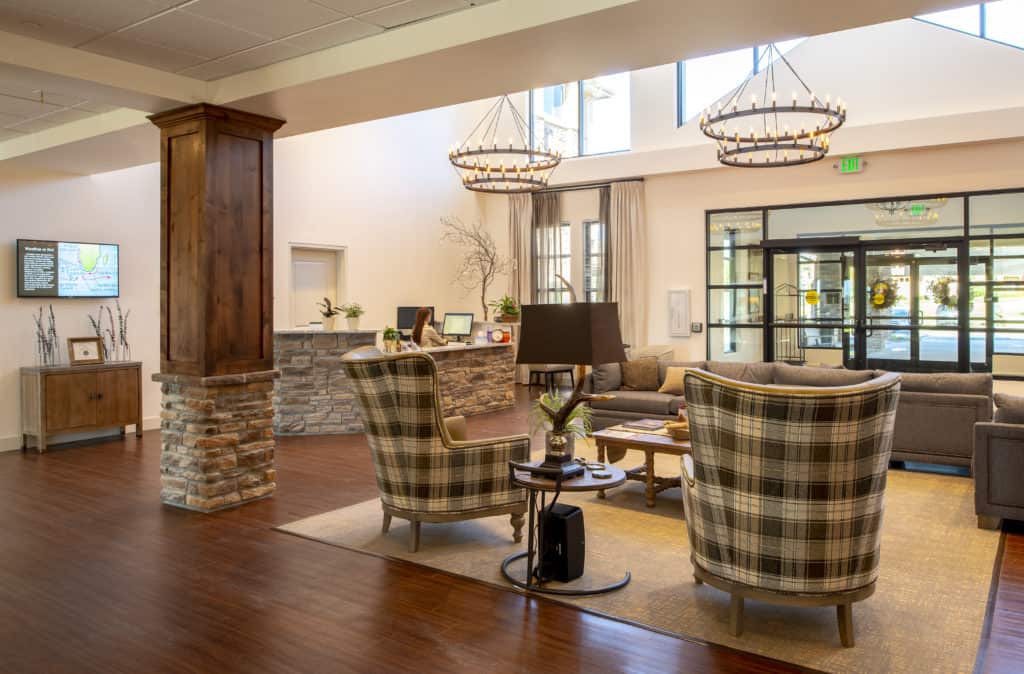 A cozy and modern lobby area with comfortable seating and elegant chandeliers.