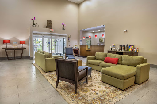 A welcoming lobby featuring comfortable green sofas and a stylish seating arrangement.