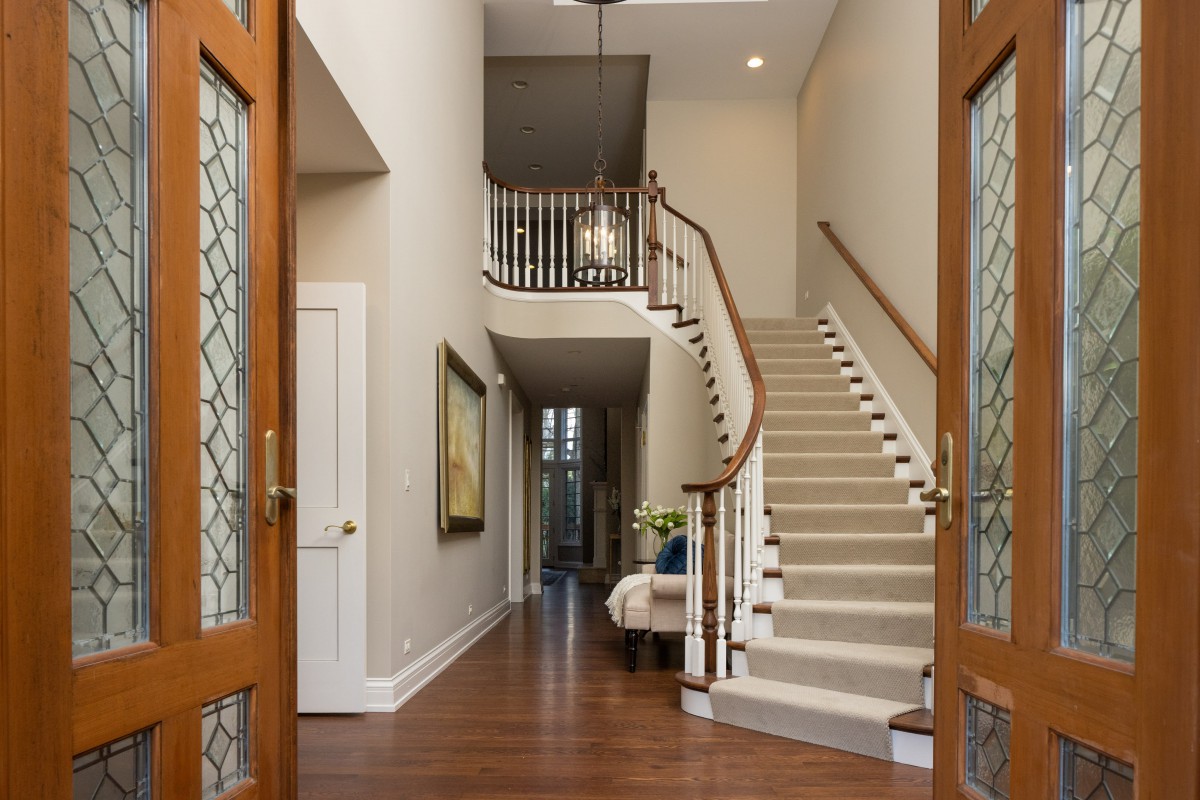 A welcoming entryway with a staircase and elegant interior design.