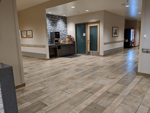 A spacious lobby area featuring modern decor and tiled flooring.