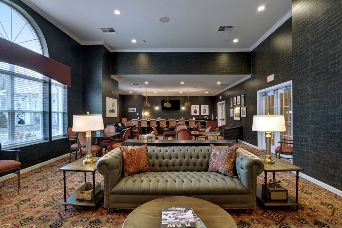 A cozy and elegantly designed living room with a comfortable sofa and warm lighting.