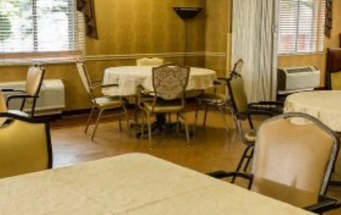 An indoor dining room with tables and chairs.