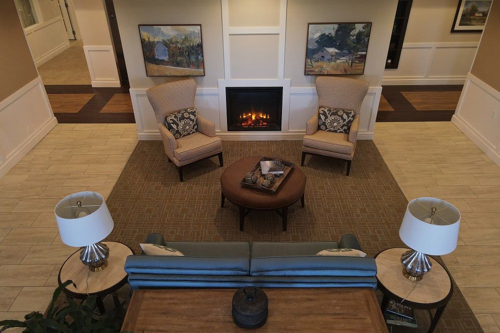 A cozy living room with a fireplace and comfortable seating arrangement.