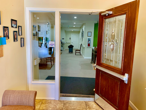 A welcoming entrance to a building featuring a glass door and an inviting lobby.